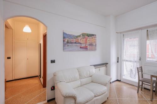 a living room with a white couch and a table at Casa Vacanze MaRoSa - Rapallo, Bixio in Rapallo