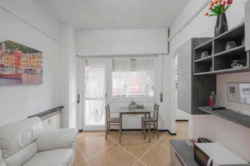 a living room with a white couch and a table at Casa Vacanze MaRoSa - Rapallo, Bixio in Rapallo