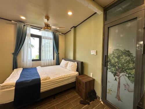 a small bedroom with a bed and a window at The mountain Seaview in Vung Tau