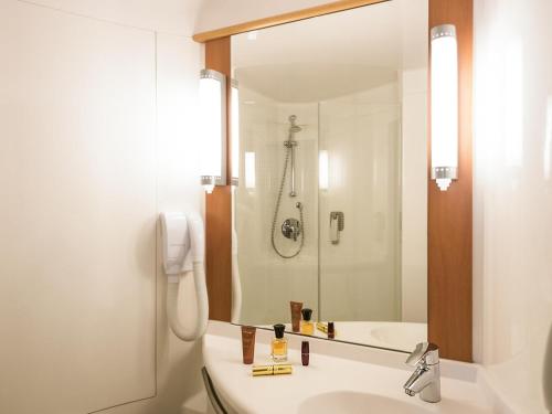 a bathroom with a sink and a shower at ibis Esch Belval in Esch-sur-Alzette