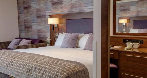 a hotel room with a bed and a desk at Invercarse Hotel Dundee, BW Signature Collection in Dundee