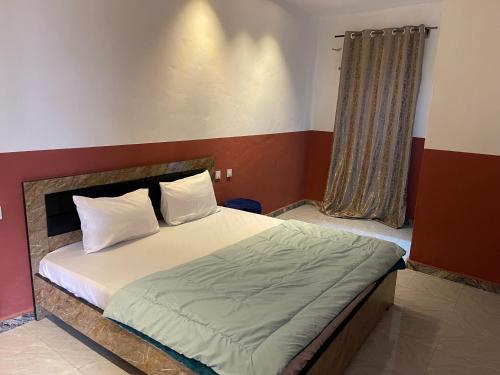 a bedroom with a large bed with at FE Purple Gold Hotel in Abuja
