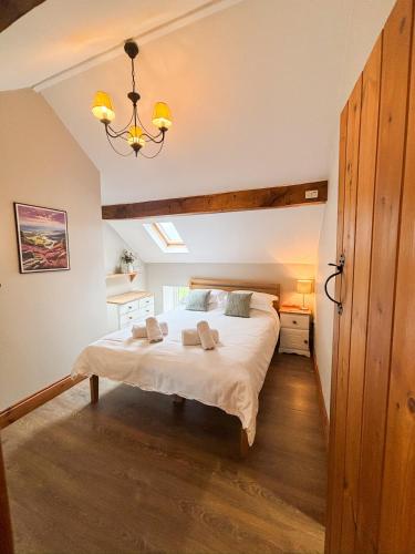 a bedroom with a large bed in a room at School House Cottage in Buxton