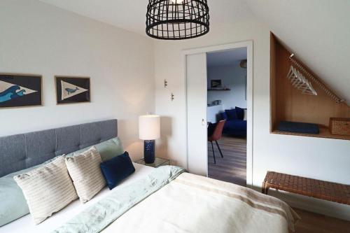 a bedroom with a bed and a lamp and a hallway at Ferienwohnung-Sturmfri-e-se in Hörnum