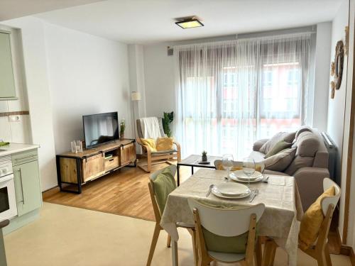 a living room with a table and a couch at El Descanso del Cares in Arenas de Cabrales