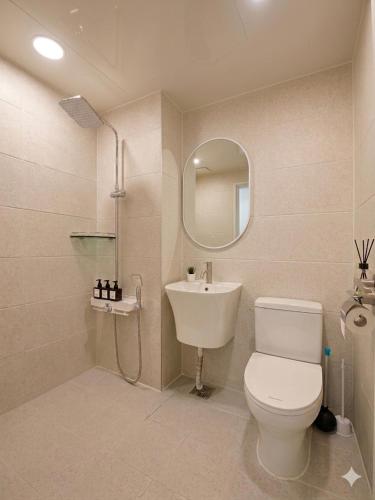 a bathroom with a toilet and a sink and a mirror at 더스테이365 스탠다드 in Seoul