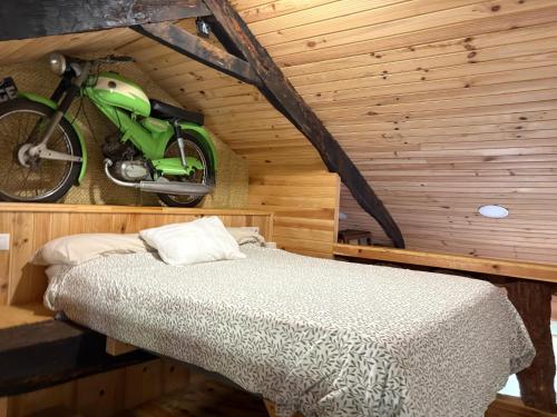 a bedroom with a bed and a motorcycle hanging on the wall at O Viraventos in Betanzos