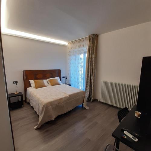 a bedroom with a large bed and a window at Angela's house in Sulmona