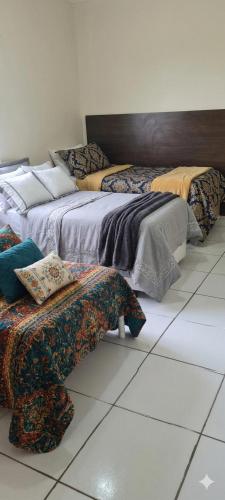 two beds sitting next to each other in a room at Chácara Recanto do Sossego in Araçoiaba da Serra