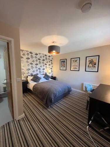 a bedroom with a bed and a striped carpet at The Red Lion Bed and Breakfast in Kings Walden