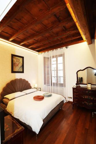 a bedroom with a large bed and a window at Casa Olaf in Cannobio