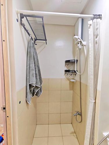a bathroom with a shower and a towel at R&N Trees Residence in Manila