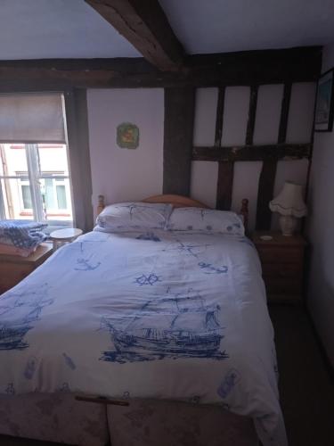 a bedroom with a large bed with a wooden headboard at The Old Sweet Shop in Harwich