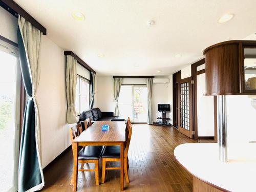 a dining room with a table and chairs at Biwa Takashima BBQ可 近湖周道路 in Takashima
