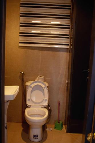 a bathroom with a toilet and a sink at Emerald Apartments in Lagos