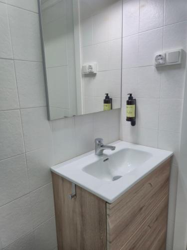 a bathroom with a sink and a mirror at Casa Anita in Luarca