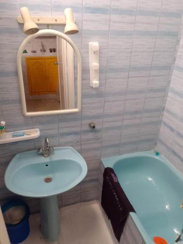 a bathroom with a sink and a mirror and a tub at Tunisian style in La Marsa