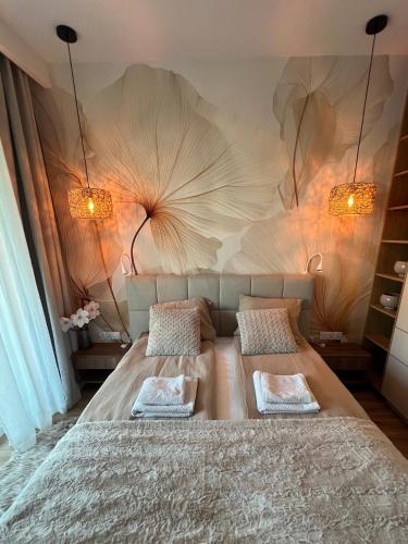 a bedroom with a large bed with two pillows at SPV Rentals Premium Apartament Wołoska 3 in Warsaw