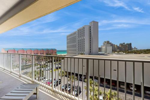 a balcony with a view of the beach and buildings at Beachfront Condo with Balcony Pools and Gym in Destin