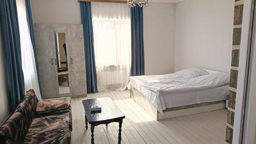 a bedroom with a bed and a mirror and a couch at Kutchak AparanQ in Kʼuchʼak
