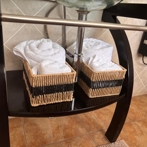 two baskets of towels sitting on a table at Ponciana Superior Guesthouse in Hartbeespoort