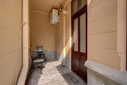 a small table sitting next to a door to a building at RHUM B07 - Old Town Courtyard in Bucharest
