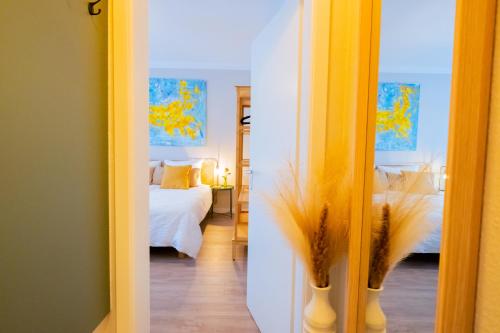 a room with a bedroom with a bed and a mirror at BetterBeds Wilhelm City in Brandenburg an der Havel