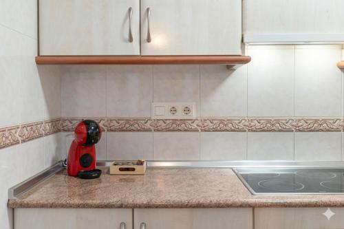 a kitchen counter with a red appliance on it at Casa Marbella in Fuengirola