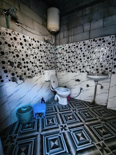 a bathroom with a toilet and a sink at The North Rememberzz in Kalgha
