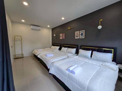 a bedroom with two large beds with white sheets at 65 Poolvilla in Ban Tao Than