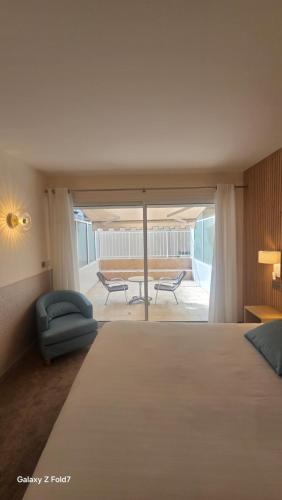 a bedroom with a bed and a chair and a table at Residence Club Inn in Nice