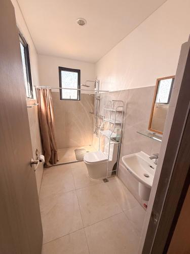 a bathroom with a toilet and a sink at Enzos Haven - Tagaytay in Tagaytay