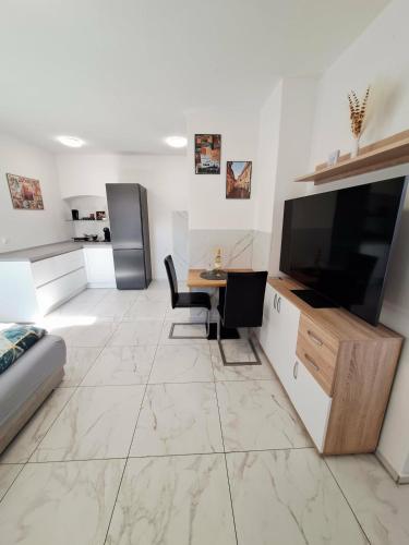 a living room with a large television and a table at Casa D'oro1700 - Old town Koper in Koper