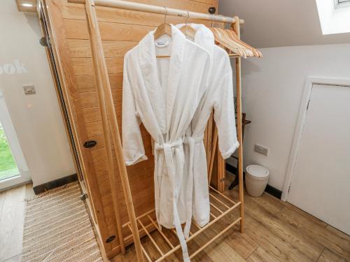 a robe hanging on a rack in a bathroom at The Retreat in Goole