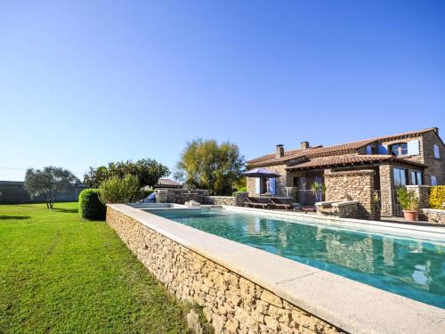 a swimming pool in front of a house at Apartment Le Platane by Interhome in Velleron