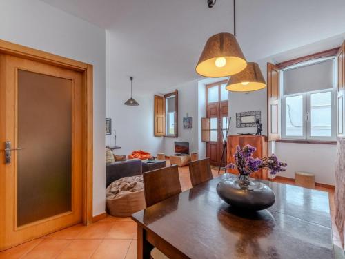 a dining room with a table and a living room at Holiday Home Rua 5 de Outubro by Interhome in Lagos
