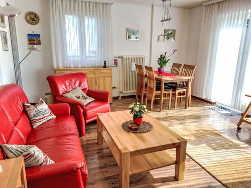 a living room with red furniture and a table at Holiday Home Mily by Interhome in Dittishausen