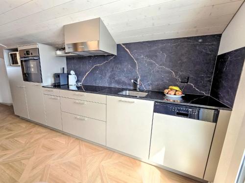 a kitchen with stainless steel appliances and a counter top at Apartment LiloTopMountainView by Interhome in Beatenberg