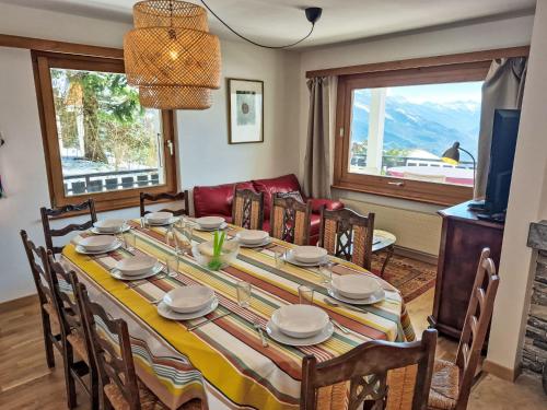 a dining room with a table and chairs at Chalet Chalet Aglaia by Interhome in Crans-Montana