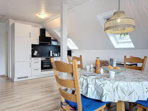 a dining room with a table and a kitchen at Apartment Am Sternberg 224 by Interhome in Frankenau