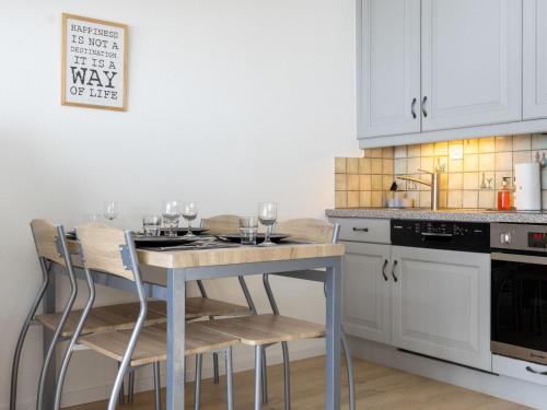 a kitchen with a table with wine glasses on it at Studio Rosablanche D63 by Interhome in Siviez