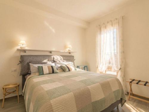 a bedroom with a large bed and a window at Apartment Nautilus by Interhome in Arzachena