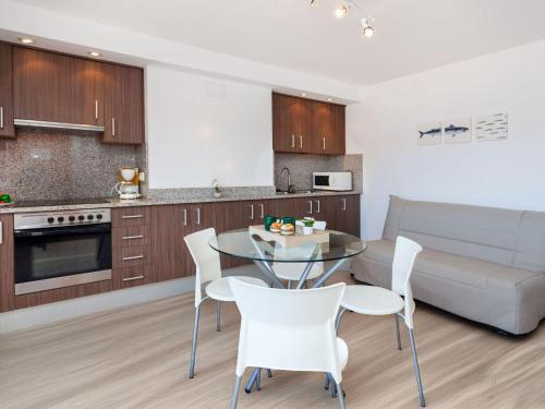 a kitchen and living room with a table and chairs at Apartment Blue Ocean-3 by Interhome in Llança