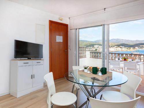 a kitchen and dining room with a glass table and chairs at Apartment Blue Ocean-3 by Interhome in Llança