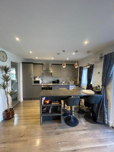a kitchen with a large table in a room at Family cottage in Epsom