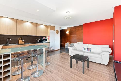 a kitchen and a living room with a white couch at GuestReady - Seaside Experience in Moledo in Moledo