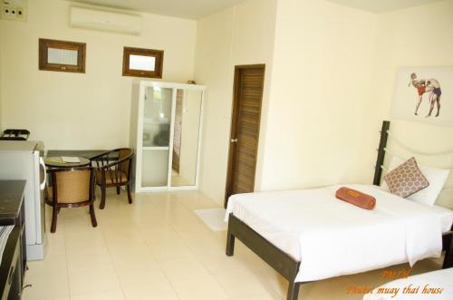 a hotel room with a bed and a table at Phuket Muay Thai House in Chalong 
