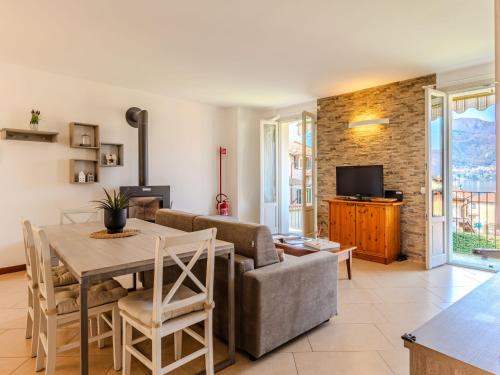 a living room with a couch and a table at Apartment di Lalla by Interhome in Lierna