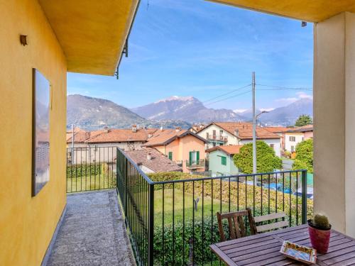 a balcony with a table and a view of mountains at Apartment di Lalla by Interhome in Lierna