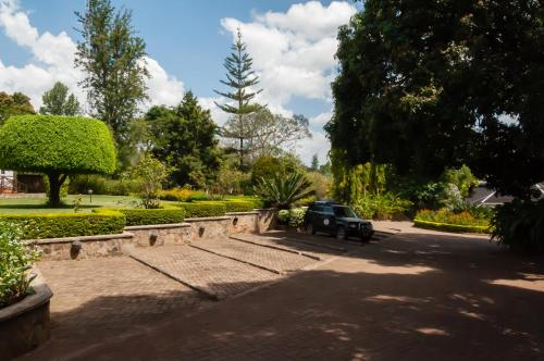 a car parked in a driveway in a park at Aishi Machame in Moshi